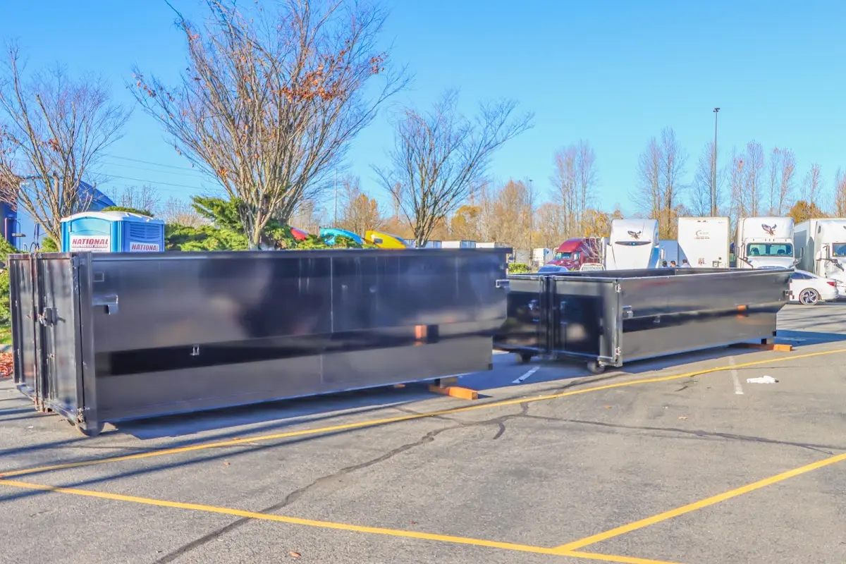 Professional dumpster rental service with roll-off container on residential driveway in Brushy Creek